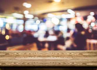 Wall Mural - empty wood table top with coffee shop blur with bokeh background