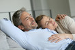 © goodluz - Mature couple relaxing in sofa, peaceful scene