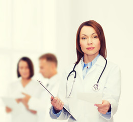 Poster - calm female doctor with clipboard