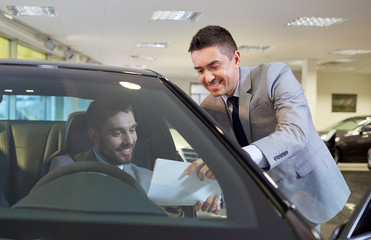 Wall Mural - happy man with car dealer in auto show or salon