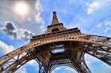 Fototapeta Na sufit - Eiffel Tower, Paris, France upward view with sun and blue sky