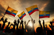Silhouettes of People Holding Flag of Ecuador Concept