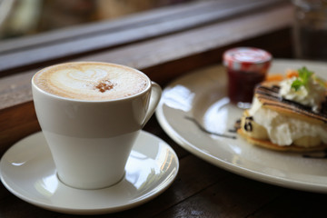 Fresh coffee on wooden table. Espresso coffee short on table.