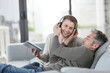 Mature couple at home listening to music with tablet