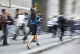 Fototapeta Miasto - motion blurred business people walking on the street
