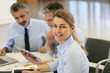 © goodluz - Smiling businesswoman attending work meeting