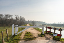 White Wooden Gate On A Dike In The Netherlands