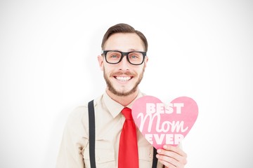 Poster - Composite image of geeky hipster smiling and holding heart card