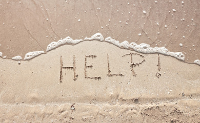 handwriting message word help at sea beach sand