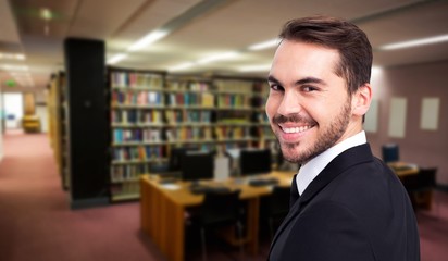 Poster - Composite image of elegant businessman in suit smiling at camera