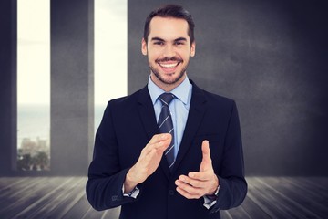 Poster - Composite image of happy businessman standing and applauding