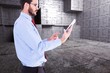 © WavebreakMediaMicro - Composite image of businessman scrolling on his digital tablet