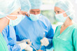 © Kzenon - Surgeons operating patient in operation theater
