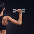 © USM Photography - Fitness woman in training muscles of the back with dumbbells