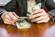 © mikitiger - businessman counts money, profit dollars