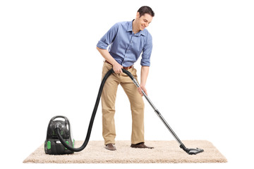 Poster - Man cleaning a carpet with a vacuum cleaner