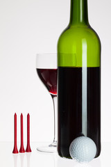 Wine glass and bottle with red wine