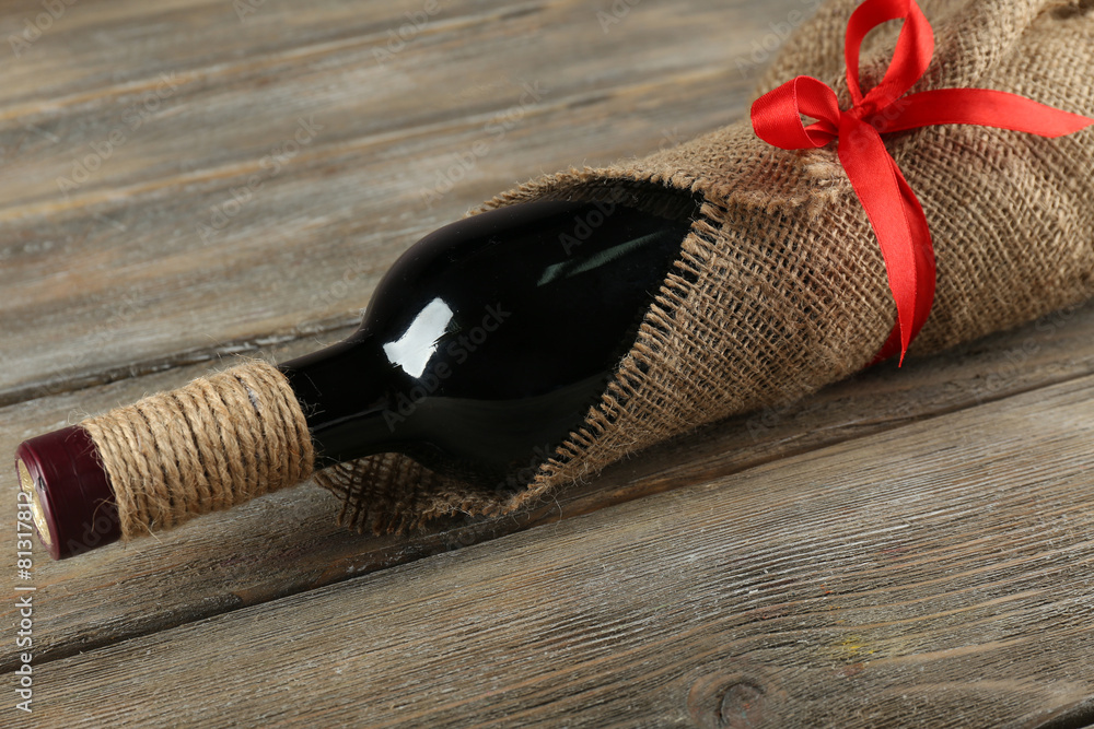 Red wine bottle wrapped in burlap cloth