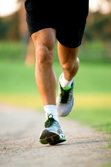 close up of runner's legs in a park