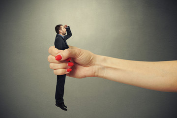 Poster - surprised man clamped in big female fist