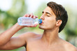 © djoronimo - Image of young man drinking water after jogging
