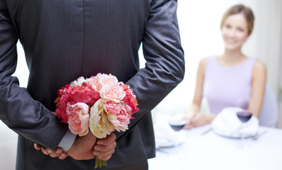 Poster - close up of man hiding flowers behind from woman