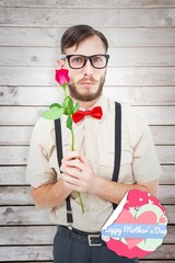 Leinwandbilder - Composite image of geeky hipster offering a rose