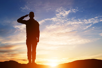 Wall Mural - Soldier salute. Silhouette on sunset sky. Army, military.