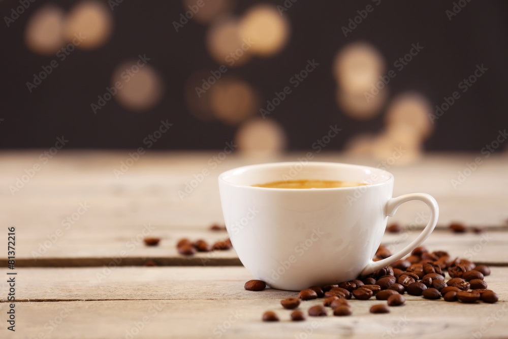 Cup of coffee on table on brown background