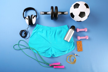 Sticker - Sports equipment and shorts on color table, top view