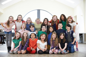 Large Group Of Children Enjoying Drama Workshop Together