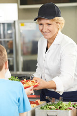 Wall Mural - Pupil In School Cafeteria Being Served Lunch By Dinner Lady