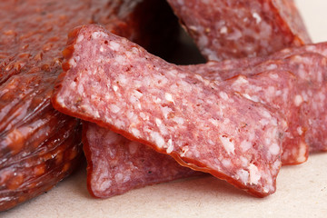 Poster - Premium salami, cut, sliced on wrapping paper. Macro.