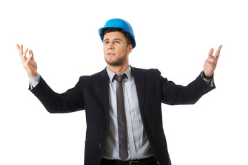 Businessman in hard hat holding copyspace.