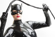 © Richard Semik - portrait of standing woman wearing latex clothes with a whip