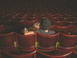 © LoloStock - Young couple sitting in movie theater