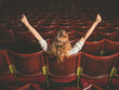 © LoloStock - Excited woman in auditorium