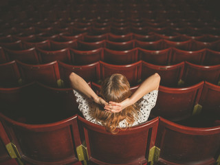 Rear view of woman in auditorium