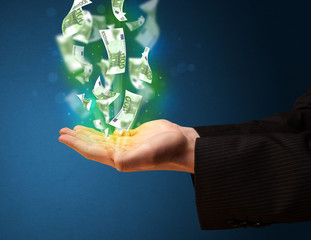 Wall Mural - Glowing money in the hand of a businessman