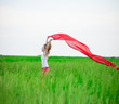 © mr.markin - Young lady runing with tissue in green field. Woman with scarf.