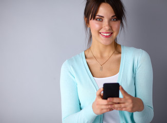 Woman using and reading a smart phone