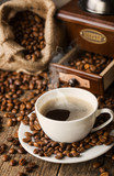 Fototapeta Boho - hot coffee and coffee beans on the background of coffee grinders