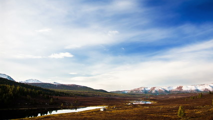 Wall Mural - Cloudy landscape with lake and mountain