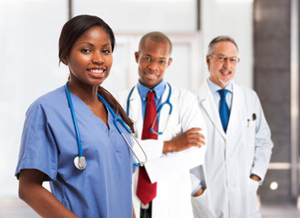 Smiling nurse in front of her medical team