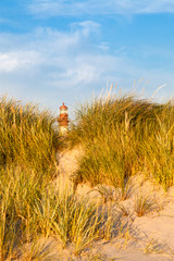 Wall Mural - Lighthouse behind sand hill