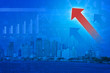 © grapestock - Red arrow head with Financial chart and graphs on city backgroun