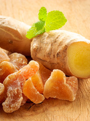 Wall Mural - Closeup root and candied ginger on wooden table