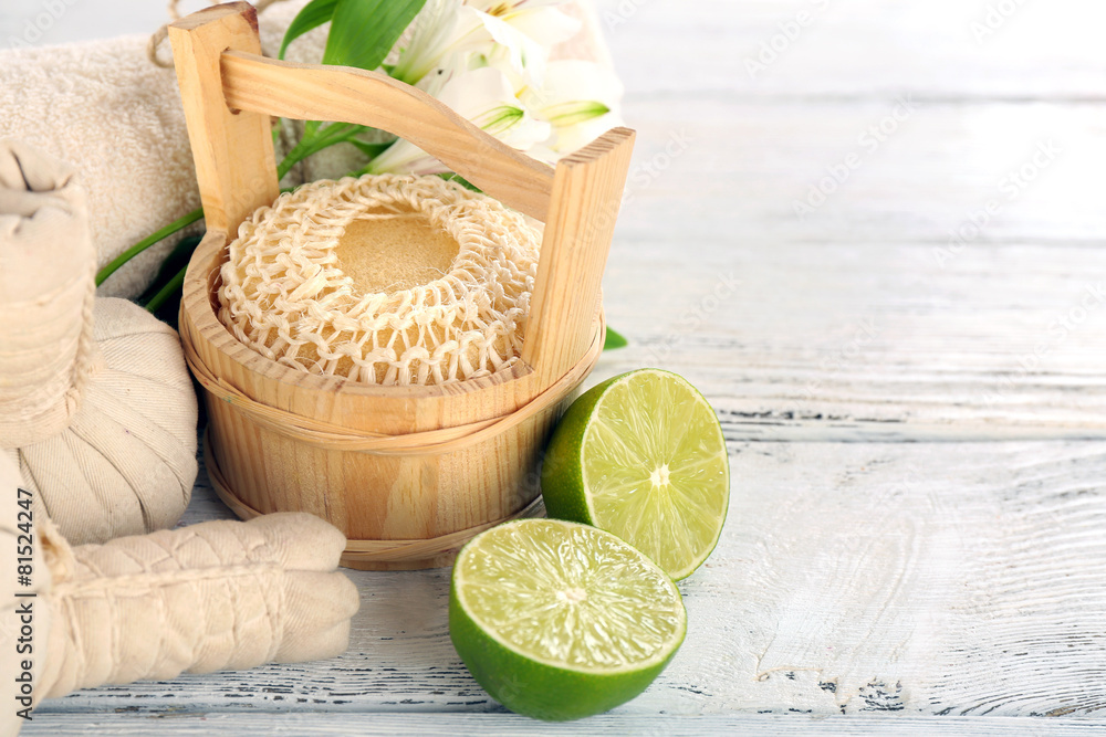 Spa still life with flower and lime on wooden table, closeup