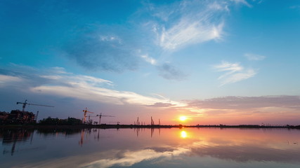 Wall Mural - sunset at lake and construction site , time lapse