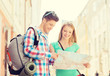 © Syda Productions - smiling couple with map and backpack in city